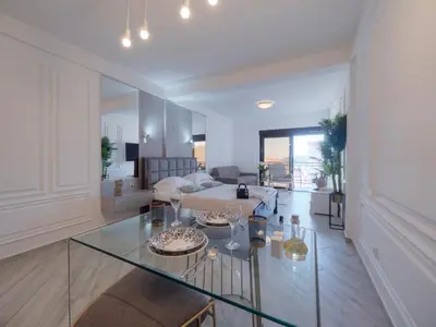 a living room with a glass table and a couch at Misisuone Apartments Budva in Budva