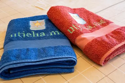 two towels sitting next to each other on a counter at Montenegro Apartments Utjeha in Utjeha