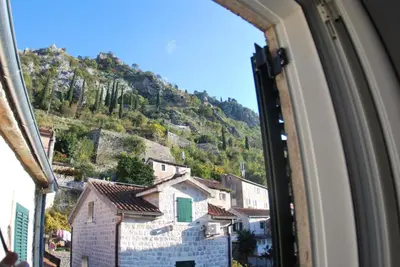 a view of a mountain from a window at Apartment Antonia in Kotor