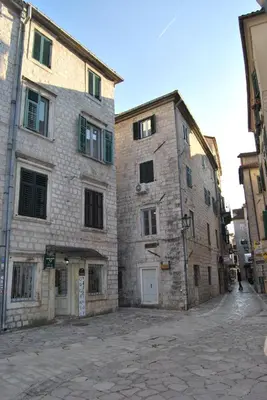 an alley with two large buildings in a city at Apartment Antonia in Kotor