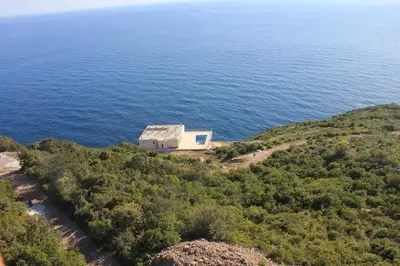 an aerial view of a house on a hill near the ocean at Charming Villa with Pool, Sea View in Zagora in Zagora