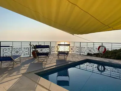 a patio with chairs and a swimming pool at Charming Villa with Pool, Sea View in Zagora in Zagora