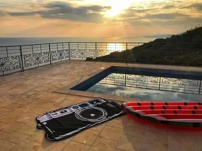 a swimming pool on top of a balcony with the sunset at Charming Villa with Pool, Sea View in Zagora in Zagora