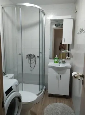 a bathroom with a shower and a toilet and a sink at Adok stan in Budva