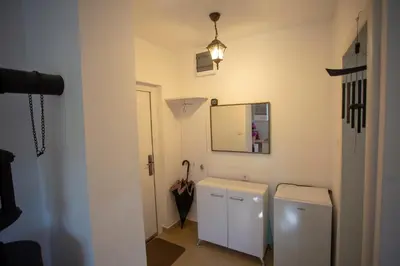 a bathroom with two toilets and a mirror and an umbrella at Уютная квартира в тени старого дуба in Becici