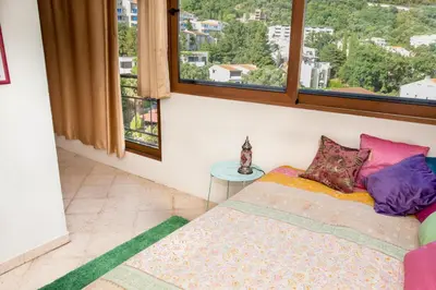 a room with a bed and a window with a view at Apartment Elena Petrovac in Petrovac na Moru