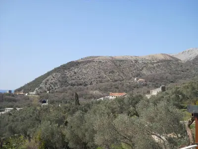 a view of a hill with houses on it at Family Stone house with magical Sea View in Kaluđerac