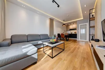 a living room with a couch and a table at Apart Compliment in Podgorica