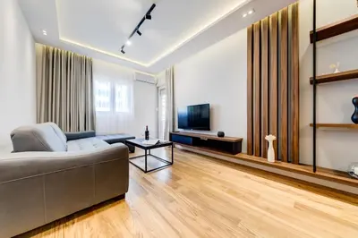 a living room with a couch and a television at Apart Compliment in Podgorica