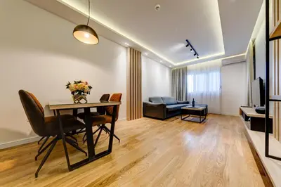 a living room with a table and a couch at Apart Compliment in Podgorica