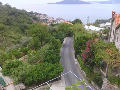 a winding road in a town next to the ocean at Apartments Mitrović Podličak in Sveti Stefan