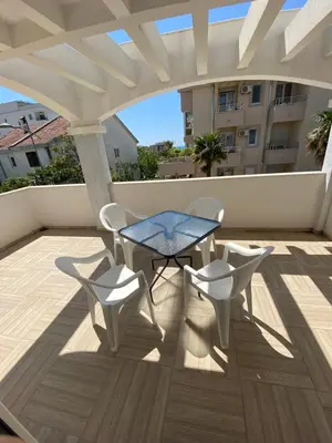 a patio with a table and chairs on a balcony at Guesthouse Civovic in Bar
