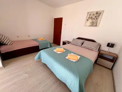 a small room with two beds in a room at Guesthouse Civovic in Bar