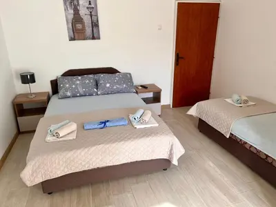 a bedroom with two beds with towels on them at Guesthouse Civovic in Bar