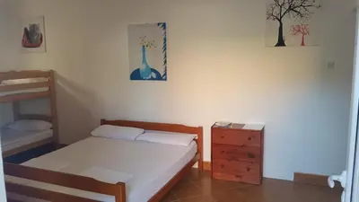 a small bedroom with a bed and a dresser at Studios Velika Plaža in Ulcinj
