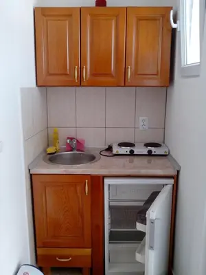 a small kitchen with a sink and a stove at Studios Velika Plaža in Ulcinj