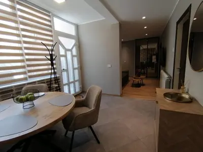 a kitchen and dining room with a table and chairs at Apartments Knežević in Ulcinj