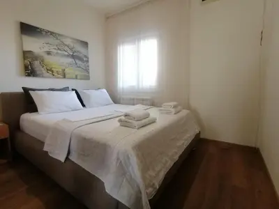 a bedroom with a bed with two towels on it at Apartments Knežević in Ulcinj