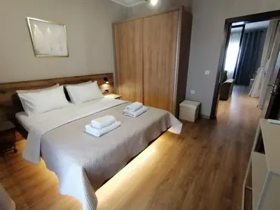 a bedroom with a bed with two towels on it at Apartments Knežević in Ulcinj