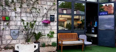 a bench sitting in front of a building at Apartments Aleksandra Cetinje in Cetinje
