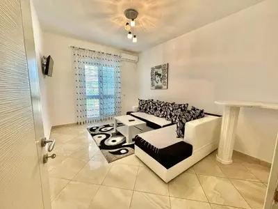 a living room with a couch and a table at Queen Kodre Apartments in Ulcinj