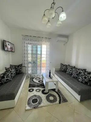 a living room with two couches and a table at Queen Kodre Apartments in Ulcinj