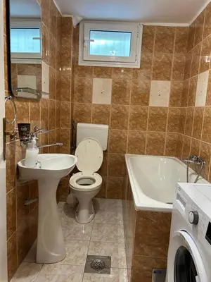 a bathroom with a toilet and a sink and a tub at Apartments Jankovic in Podgorica