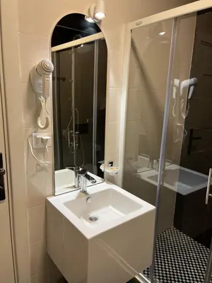 a white bathroom with a sink and a shower at Bella Vista B&B in Ulcinj