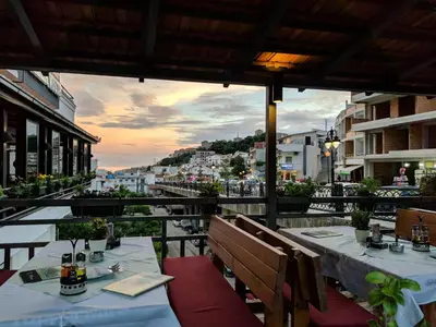 a restaurant with two tables and a view of a city at Bella Vista B&B in Ulcinj