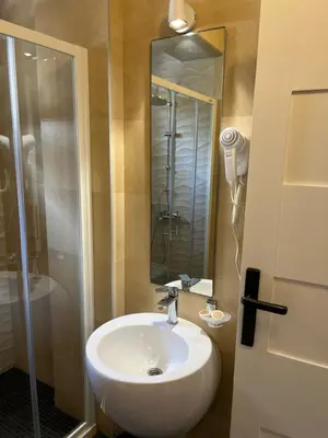 a bathroom with a white sink and a shower at Bella Vista B&B in Ulcinj