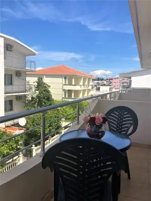 a vase of flowers sitting on a table on a balcony at Lazorja Rooms in Ulcinj