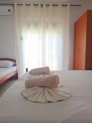 two towels are sitting on top of a bed at Lazorja Rooms in Ulcinj