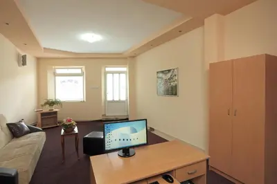a living room with a tv and a couch at Apartments Bokan in Cetinje