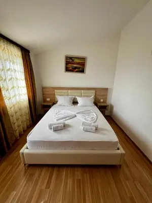 a bedroom with a bed with two towels on it at Apartments Rudaj in Ulcinj