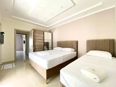 two beds in a room with two white beds at Fimi Apartments in Ulcinj