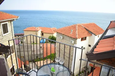 a balcony with a table and glasses of wine at Villa Dulcinea in Ulcinj
