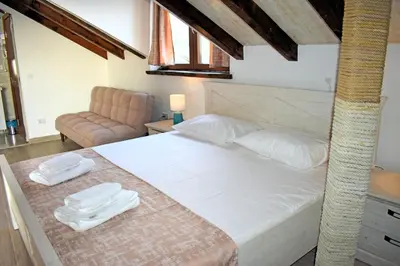 a bedroom with a bed with towels on it at Villa Dulcinea in Ulcinj
