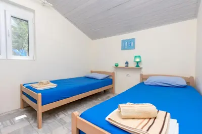 a bedroom with two beds and a window at House Carpe Diem with the best sea view in Masline