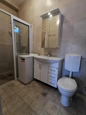 a bathroom with a white toilet and a sink at House Carpe Diem with the best sea view in Masline
