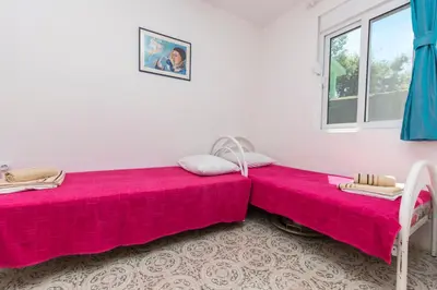 two beds sitting next to each other in a room at House Carpe Diem with the best sea view in Masline
