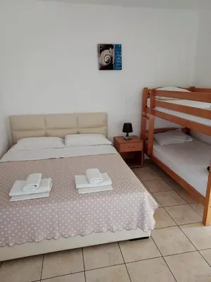 a bedroom with a bed with two towels on it at Apartments Beba Zalad in Sutomore