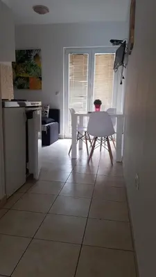 a person sitting at a table in a kitchen at Apartments Beba Zalad in Sutomore