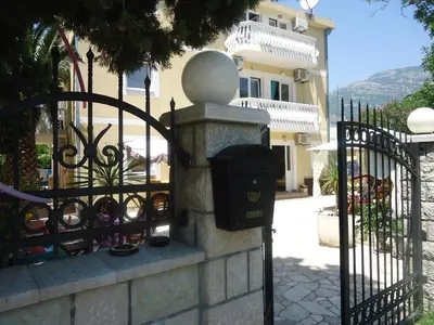 a fence with a parking meter next to a gate at Apartments Beba Zalad in Sutomore