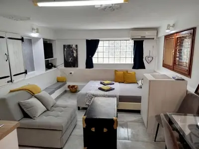 a living room with a couch and a table in it at Apartman Art in Kotor