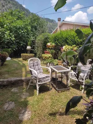 two chairs and a table in a yard at Apartman Art in Kotor