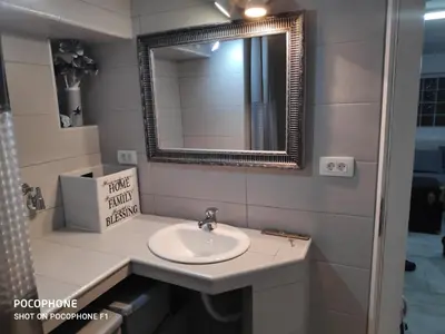a bathroom with a sink and a mirror at Apartman Art in Kotor