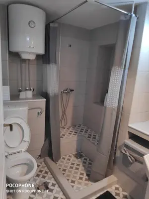 a small bathroom with a toilet and a shower at Apartman Art in Kotor