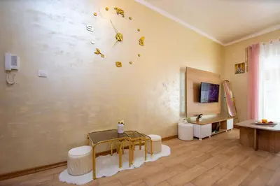 a room with a table and a clock on the wall at Krizor Apartman Budva in Budva