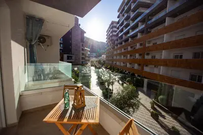 a bench on a balcony with a view of a street at Krizor Apartman Budva in Budva