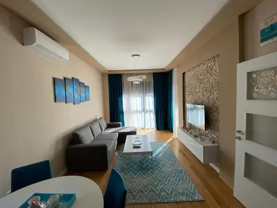 a living room with a couch and a table at Apartment Sofia, City Centar in Podgorica
